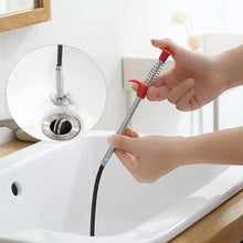 Sturdy metal wire brush with a hook for easy cleaning of kitchen sinks and clogged drains.